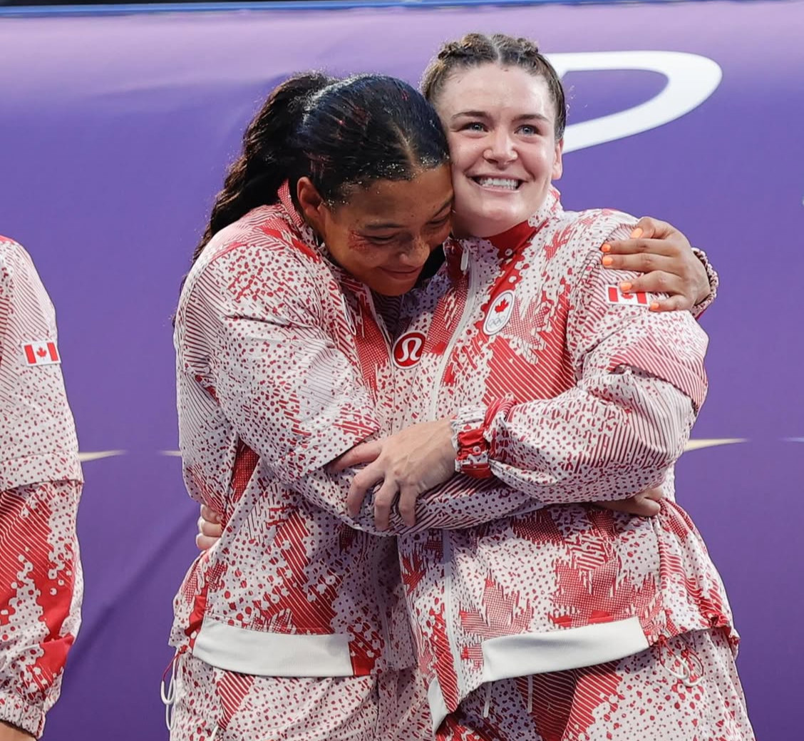 Asia hugging teammate
